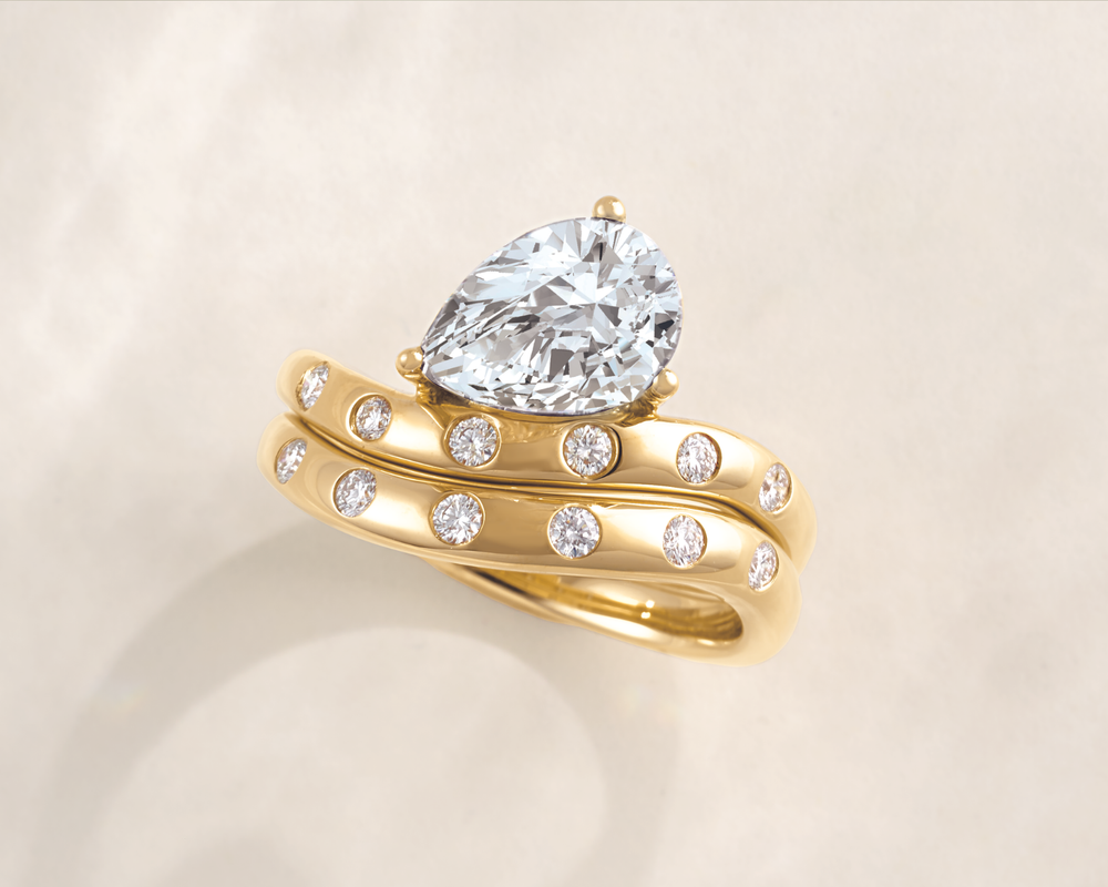 1 carat pear shaped diamond ring on a finger showing teardrop shape and finger-lengthening effect 1 carat pear shaped diamond ring on a finger showing teardrop shape and finger-lengthening effect